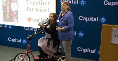 Janessa Joseph, left, and her mother, Julie Joseph, celebrate Janessa's first time on her new adaptive bike during Tuesday's event at Capital Blue Cross headquarters in Harrisburg.